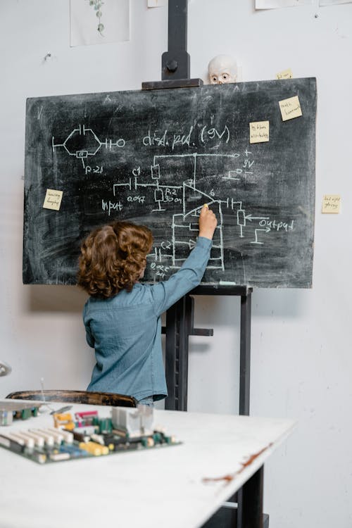 Free Smart Kid Solving a Science Problem Stock Photo