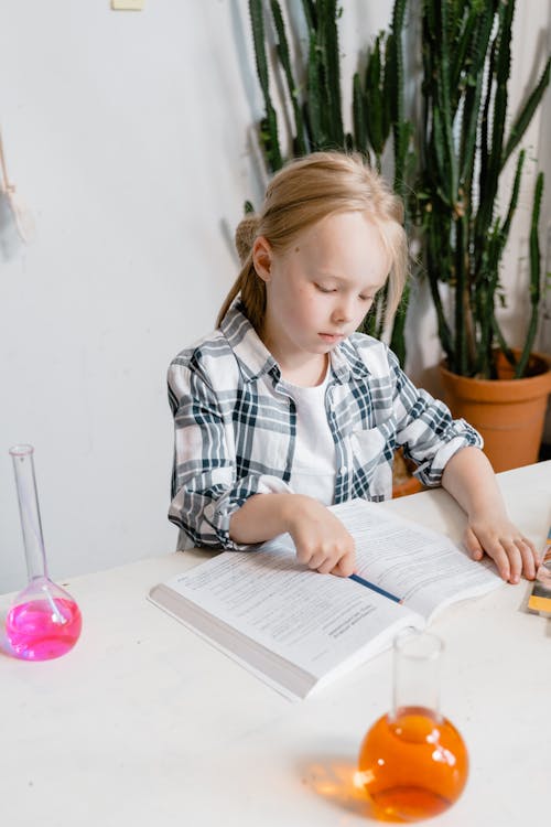 Free Smart Girl Reading a Textbook  Stock Photo