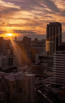 Stunning view of Curitiba skyline during sunset with vibrant colors and urban architecture.
