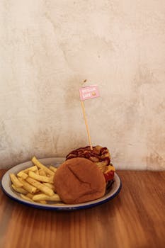 A delicious vegan burger with fries on a plate with a rustic background, ideal for food photography.
