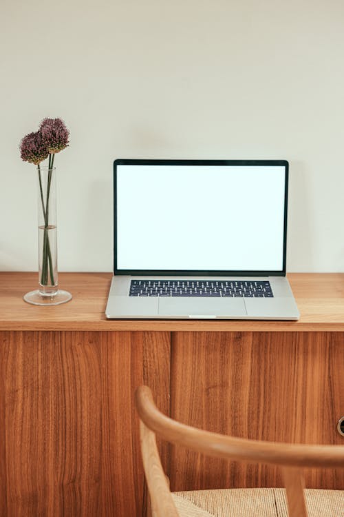 Free Laptop Placed on Top of a Wooden Desk Stock Photo