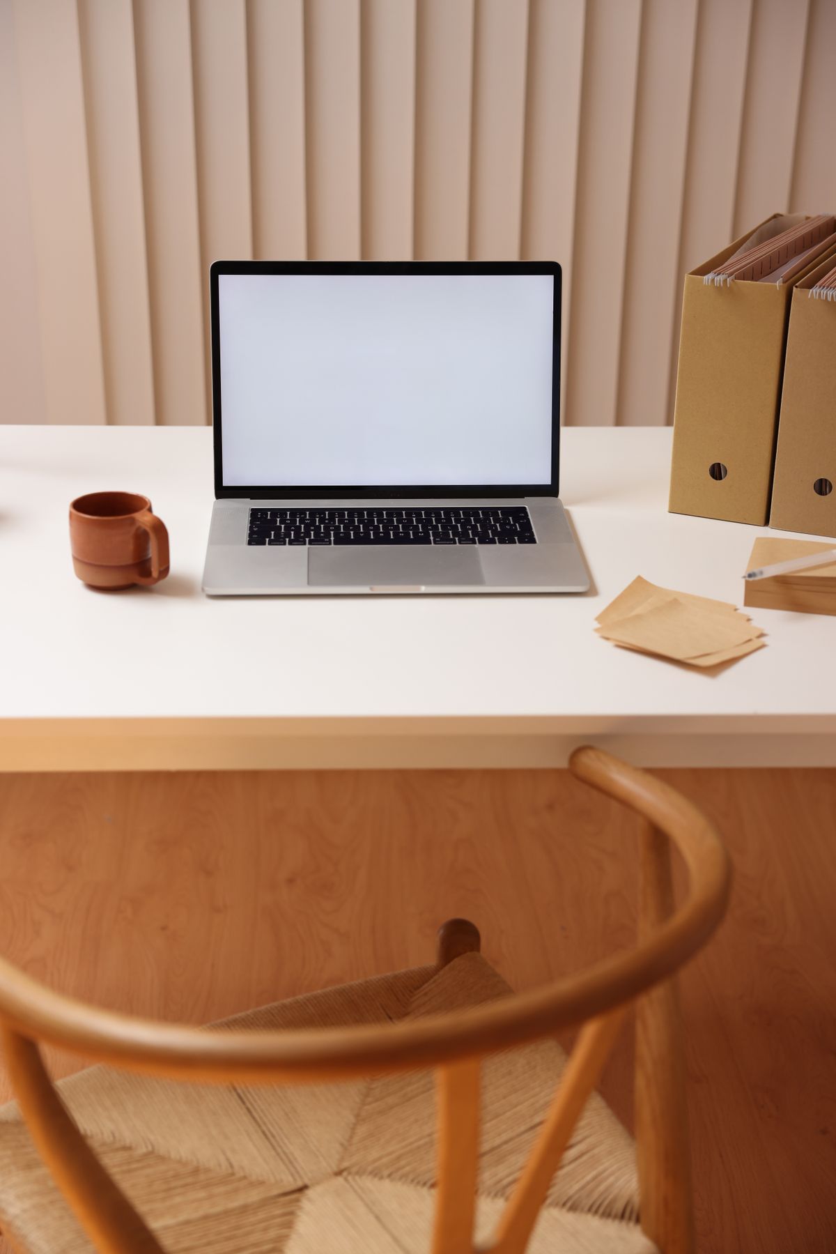 A minimalist workspace with a single laptop and plenty of empty space