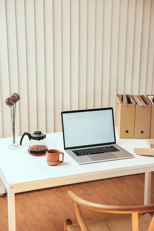 Free A Macbook on White Table Stock Photo