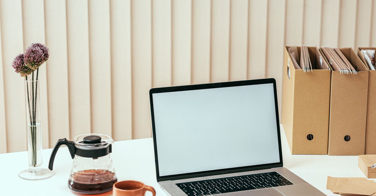 A Macbook on White Table · Free Stock Photo