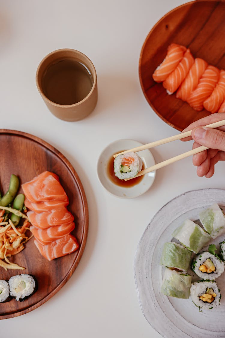 Sushi And Sashimi On Wooden Plates