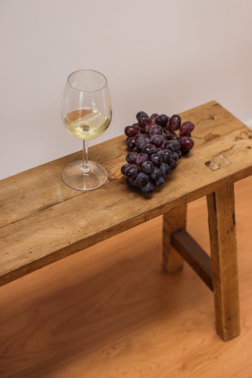 Clear Wine Glass on Brown Wooden Table