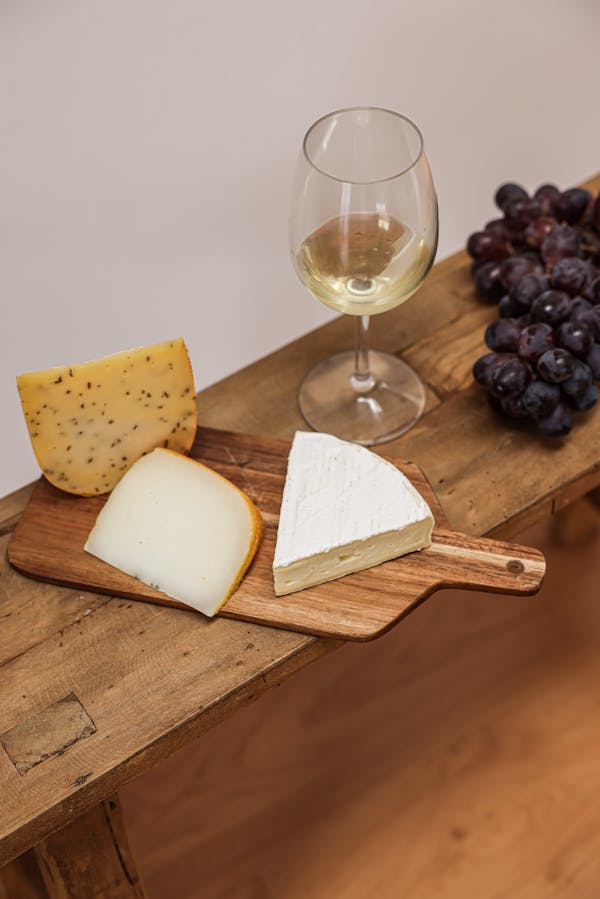 Assorted Cheese on Wooden Chopping Board 