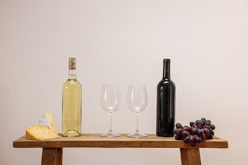Wineglasses Between Bottles of Wine on Table