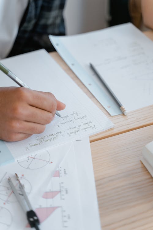 Person Writing on a White Paper