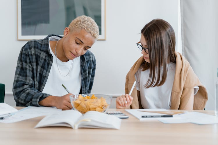 Man And A Woman Studying Together