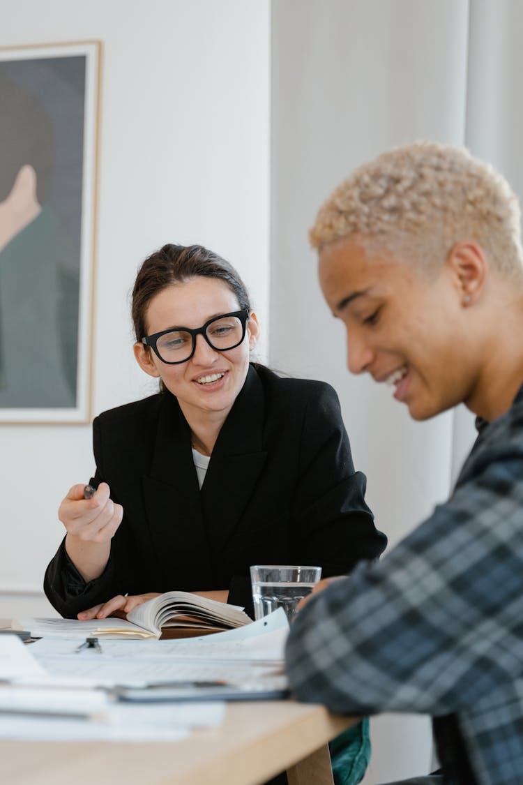 A Woman Tutoring A Young Man