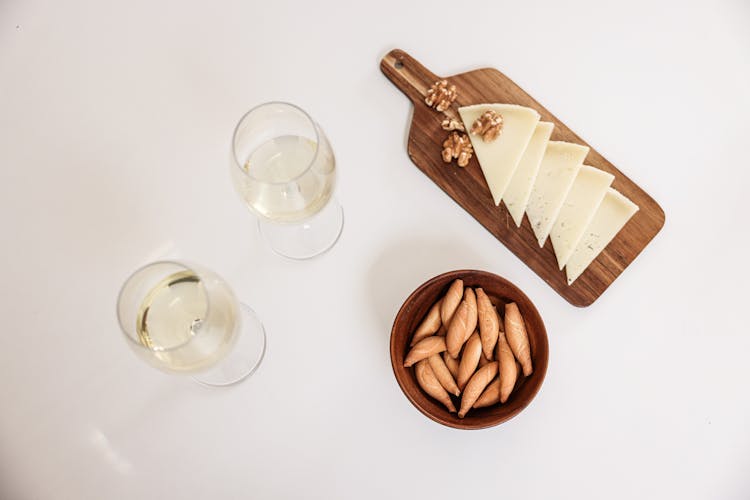 Overhead Shot Of Glasses Of Wine And Cheese Slices