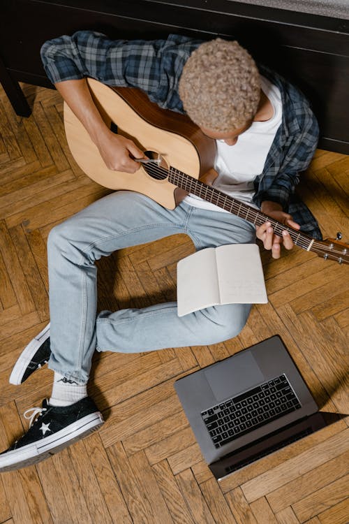 Kostnadsfri bild av akustisk gitarr, anteckningsbok, bärbar dator