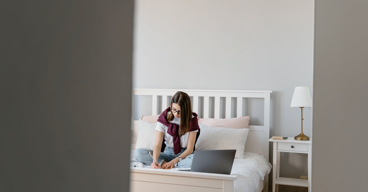 Teen girl focused on homework in a peaceful bedroom setting. Casual, educational scene.