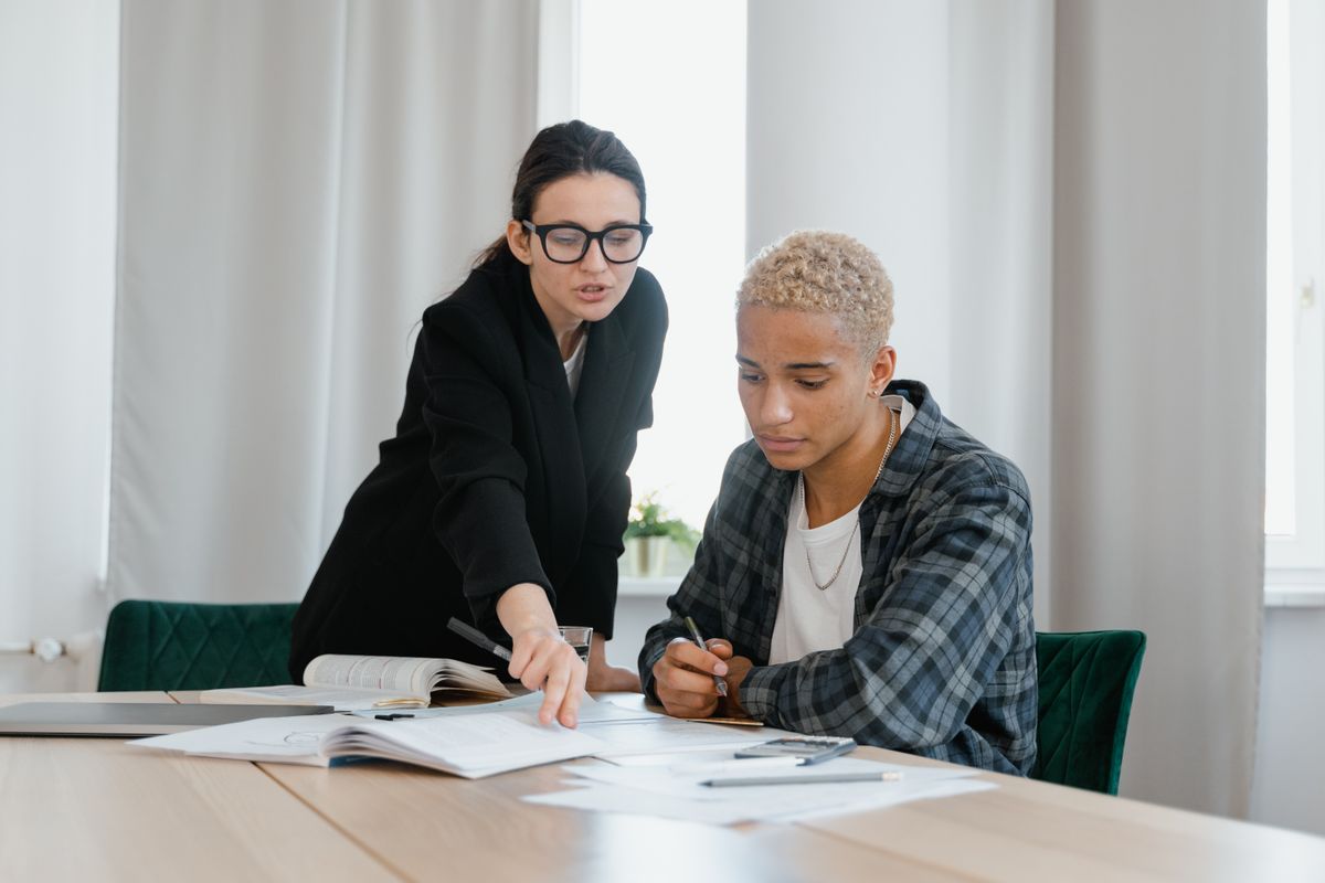 Mentor supporting a young person in a one-to-one study session