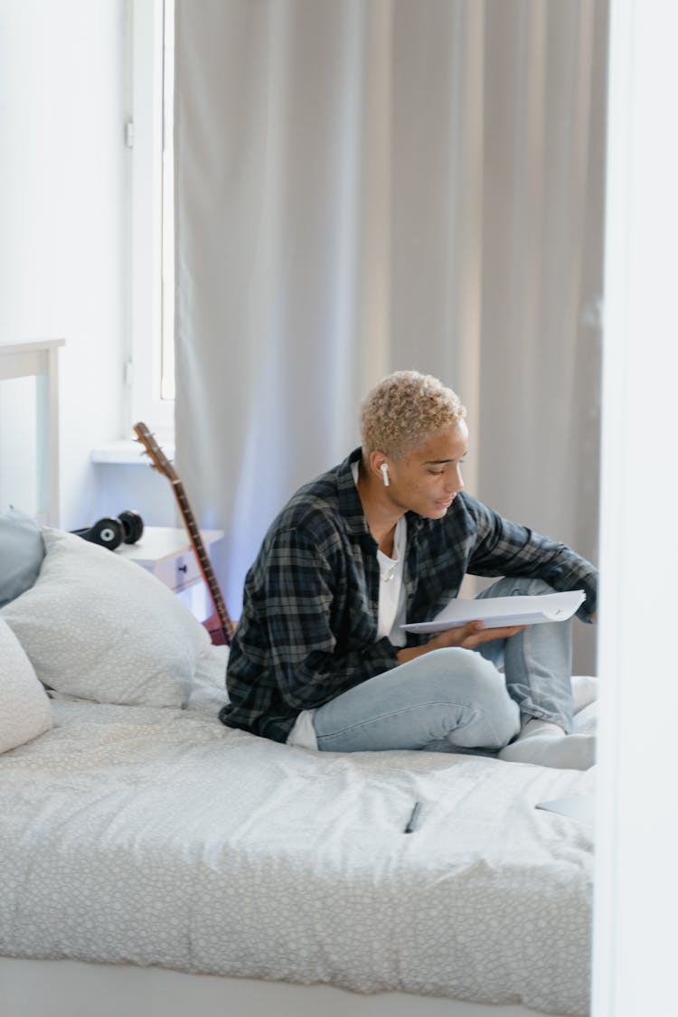 Student Studying While Sitting On Bed 