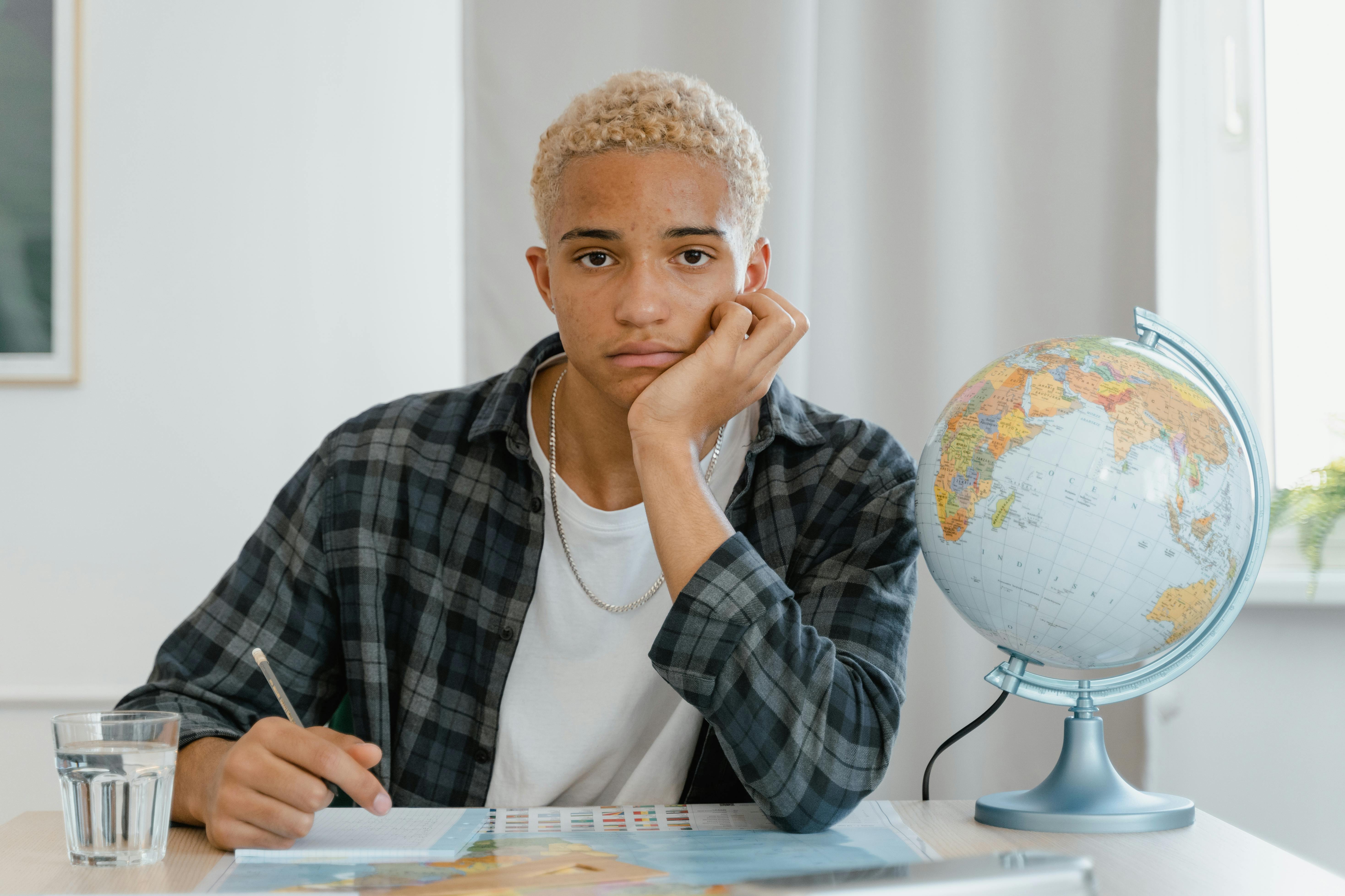 Man in Black and White Plaid Dress Shirt Holding Pen