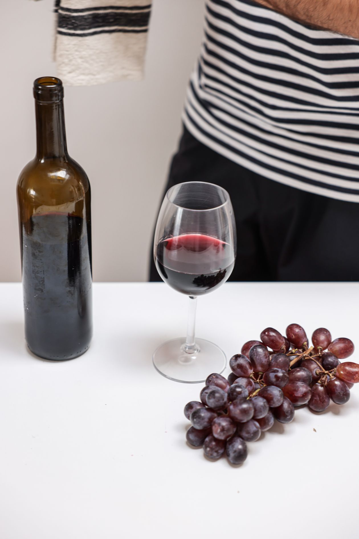 Bottle of 2019 Tannin Ridge Cabernet Sauvignon with glass and grapes