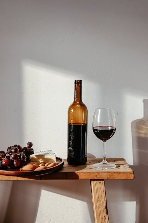 grátis Foto profissional grátis de copo de vinho, frasco, placa de charcutaria Foto profissional