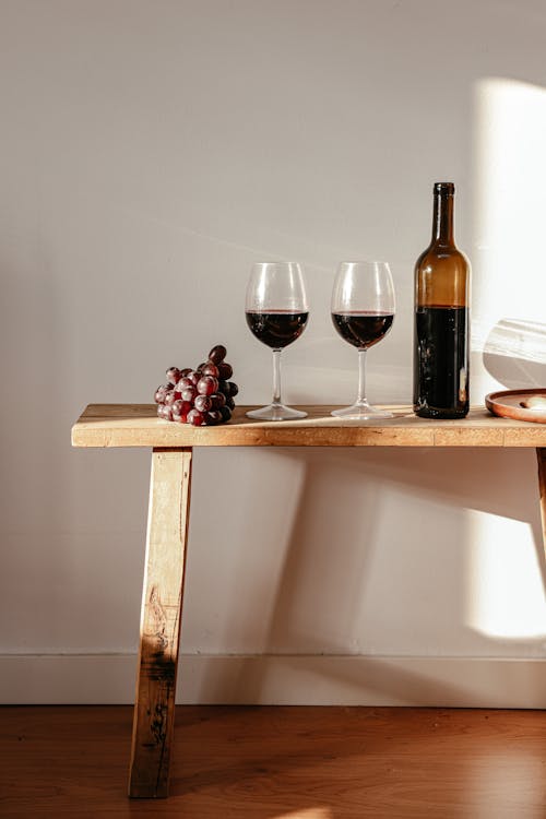 Free Wine Bottle and Wine Glasses on Wooden Table Stock Photo