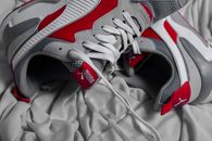 Pair of stylish sneakers on creased cloth