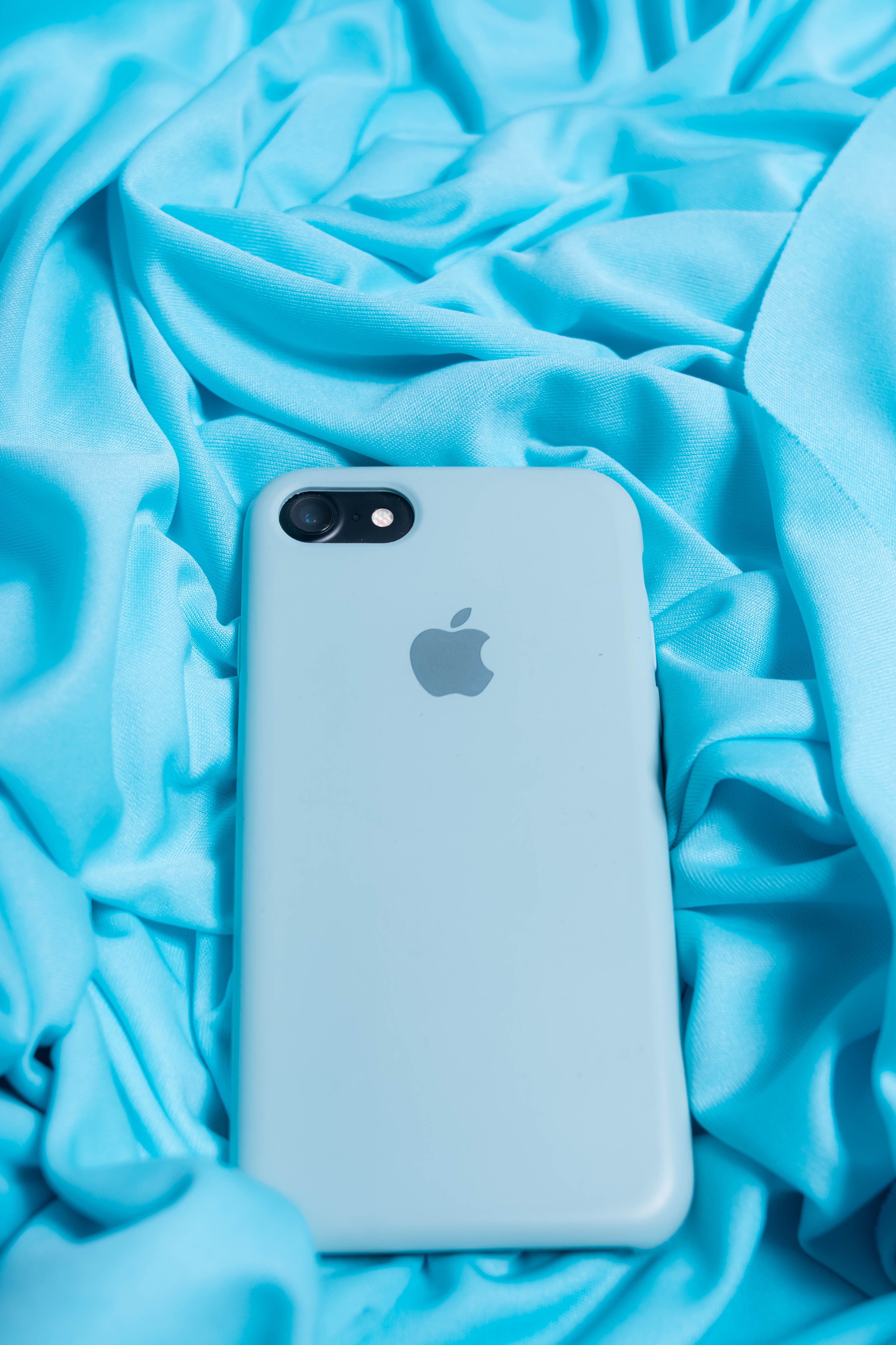 From above of modern cellphone in light blue case on creased silk fabric - Understanding the Different Types of Mobile Accessories