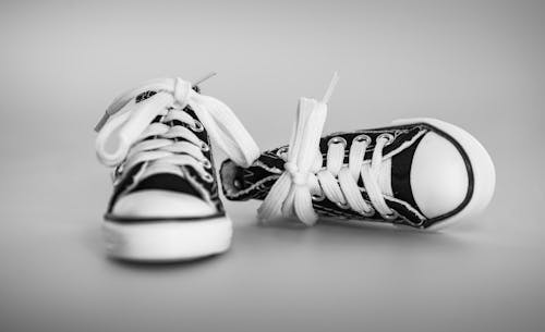 Free Pair of Laced-up Black Low-top Sneakers Stock Photo