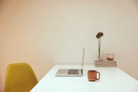 Side View of a Laptop and Cup of Coffee on a Table
