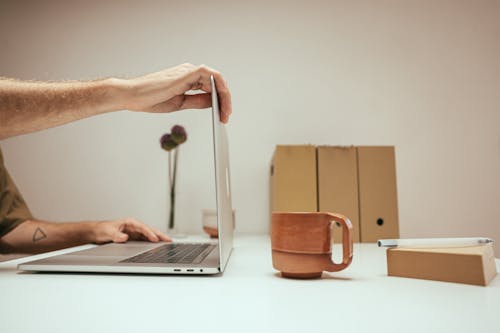 Person Using Silver Macbook Air