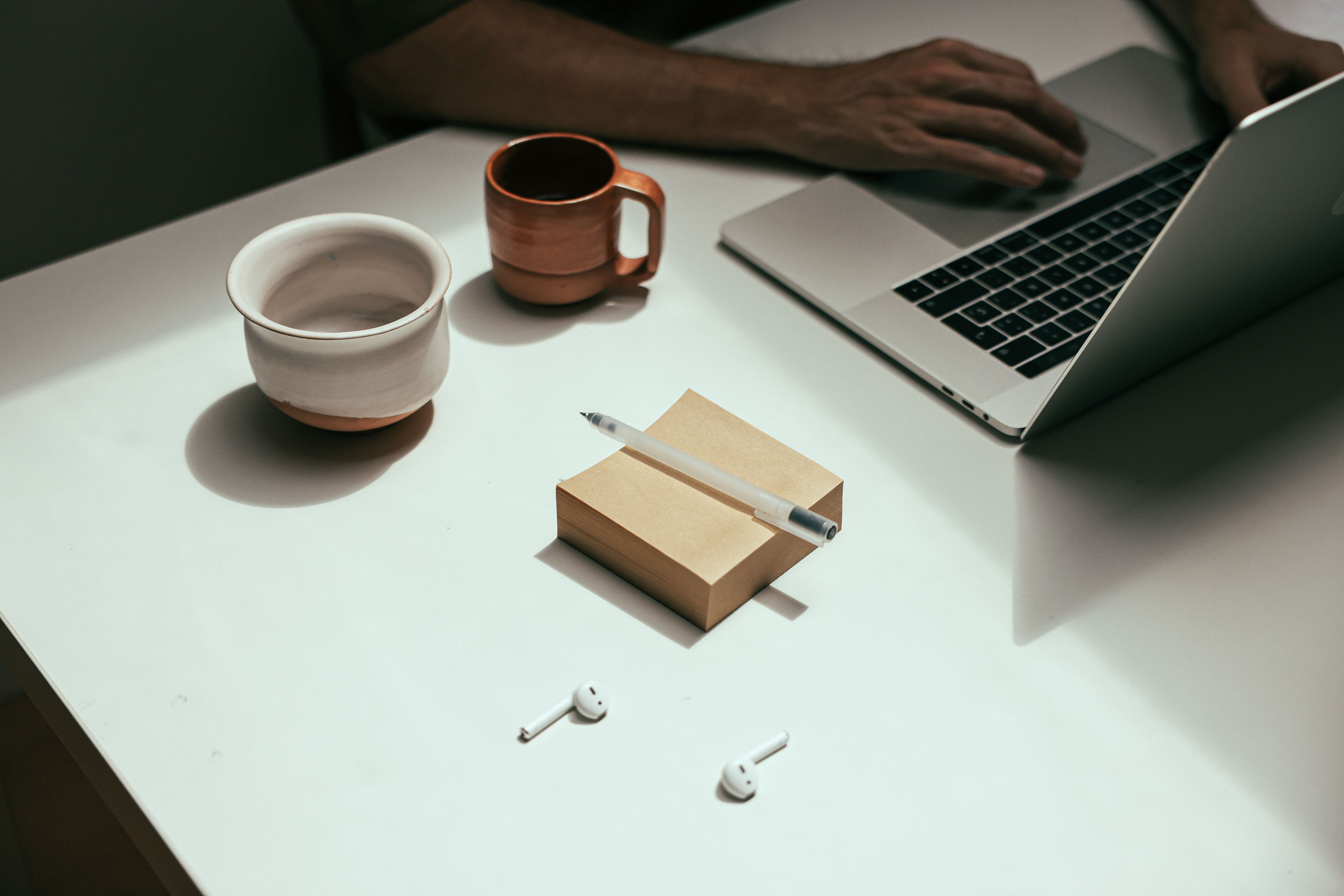 person working at clean minimal desk with morning light