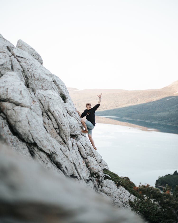 A Man Climbing The Rocky Mountain