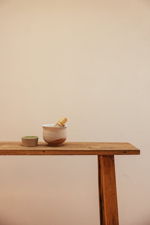 Free Bamboo Whisk on a Bowl beside a Bowl of Ceremonial Grade Matcha  Stock Photo