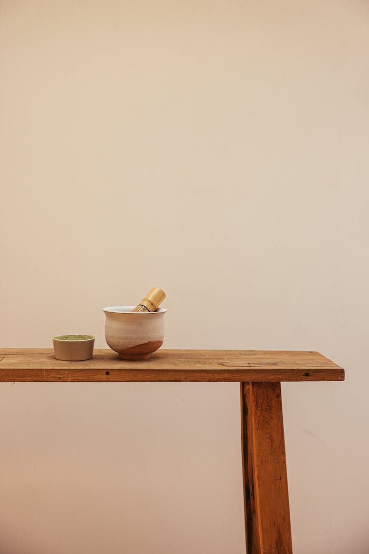 Bamboo Whisk On A Bowl Beside A Bowl Of Ceremonial Grade Matcha 