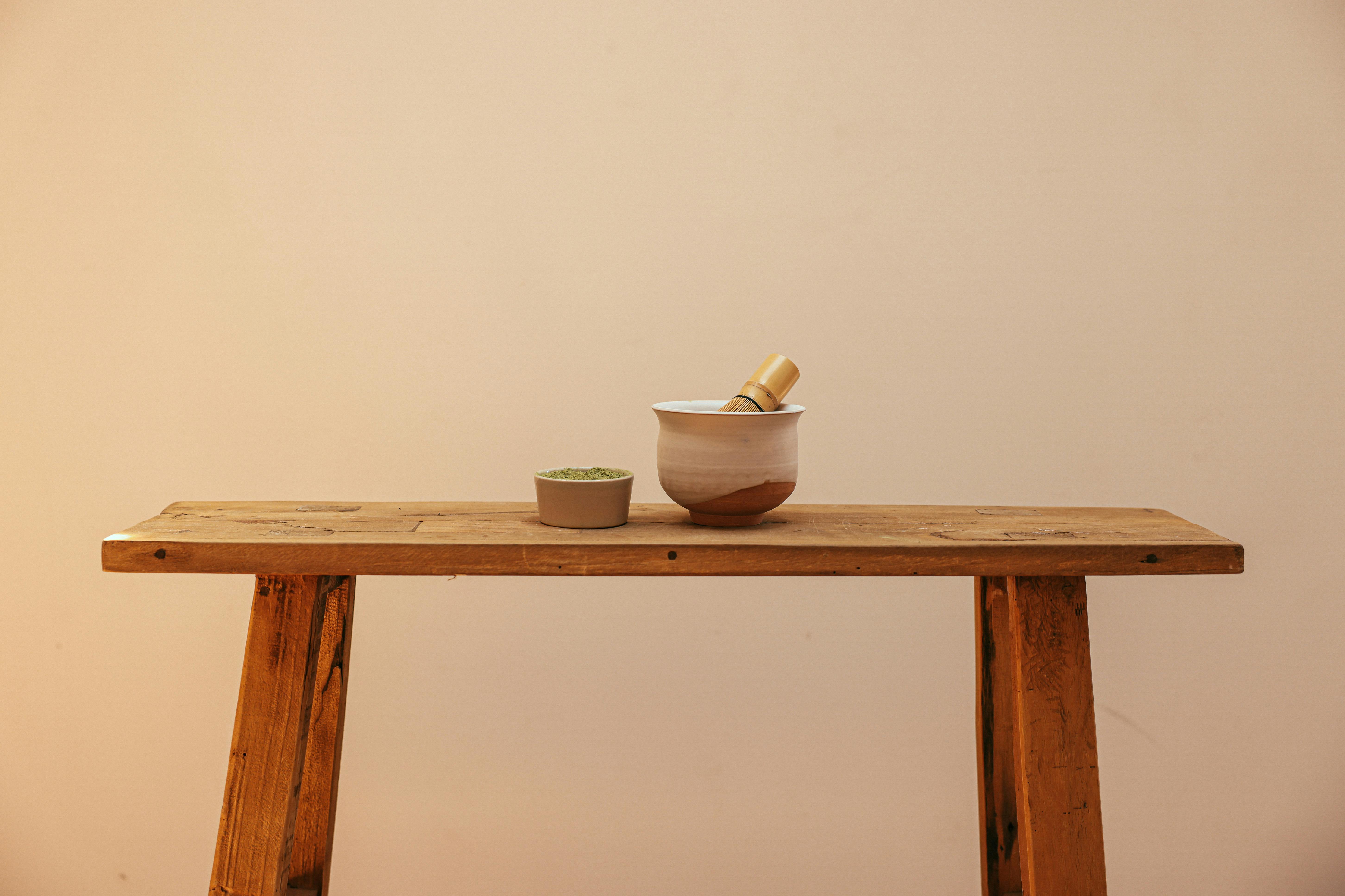 white ceramic bowl on brown wooden bench