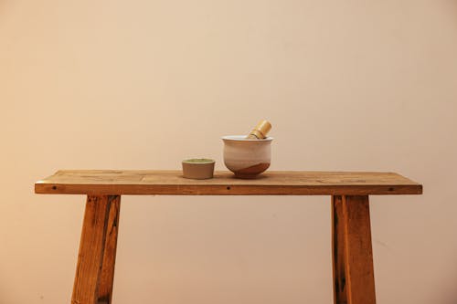 White Ceramic Bowl on Brown Wooden Bench