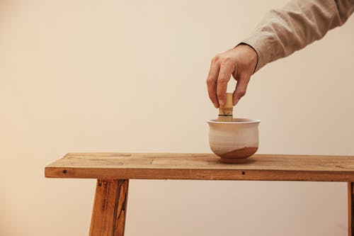 Free A Person Mixing Tea on a Ceramic Cup Stock Photo
