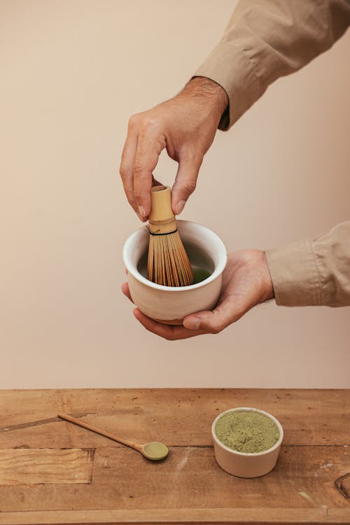 A Person Holding White Ceramic Cup