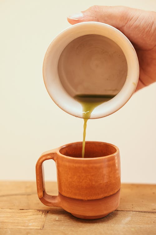 Pouring Green Tea on Mug