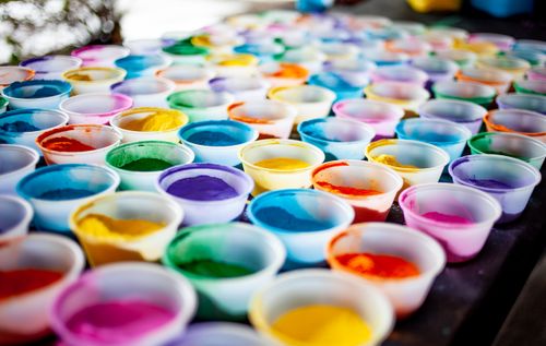 Free A vivid display of multicolored powders in plastic cups, ideal for arts and crafts projects. Stock Photo