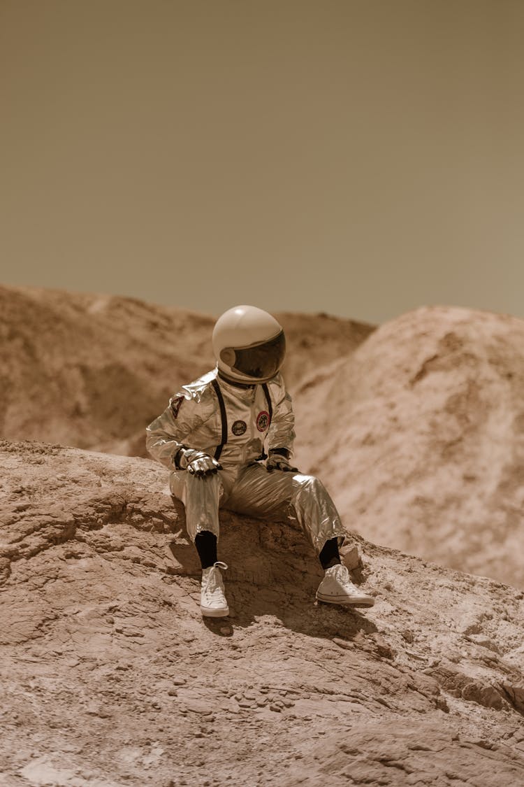 Astronaut Sitting On A Rock On Mars 