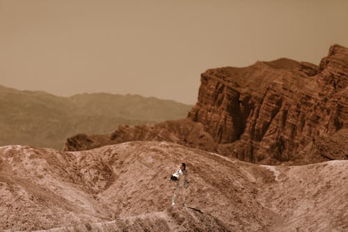 Astronaut Standing with a Helmet in her Hand on Mars 