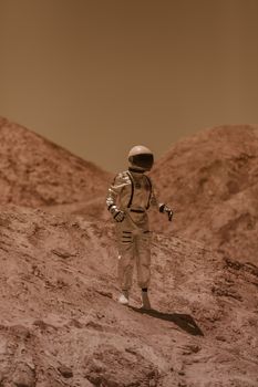 Astronaut in a space suit exploring a desert landscape resembling Mars.