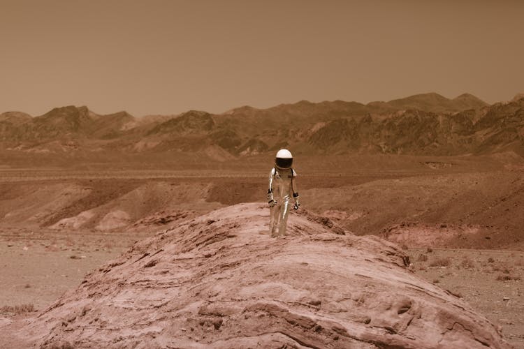 Person In Spacesuit Walking On Dry Land