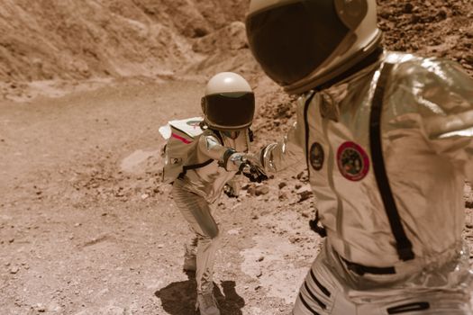 Man in White and Black Stripe Long Sleeve Shirt and Helmet Standing on Brown Sand during
