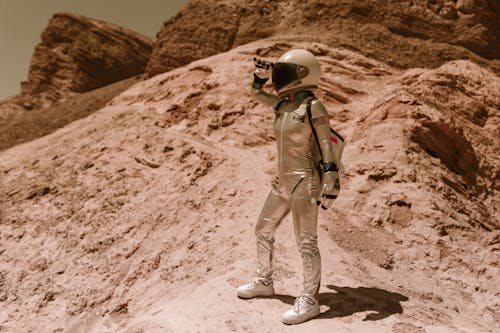 Astronaut Standing on a Rock on Mars and Looking 