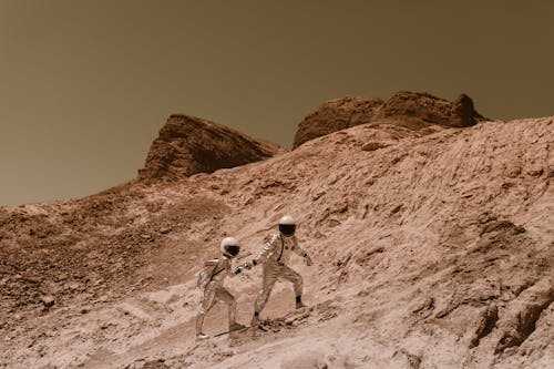 Astronauts Holding Hands and Walking up the Hill on Mars 