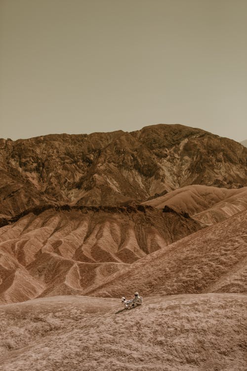 Astronauts Sitting on the Ground on Mars Surface 