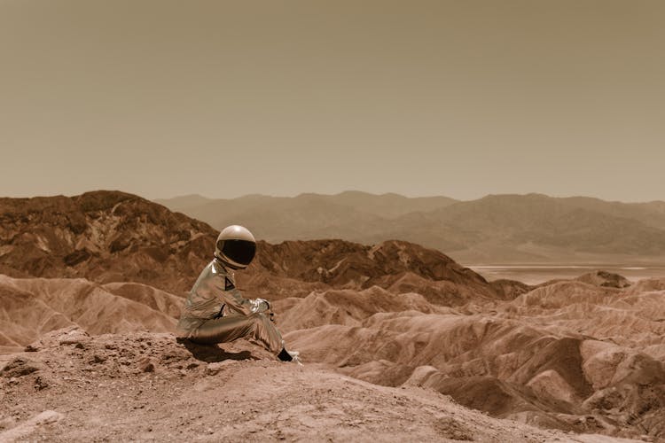 An Astronaut Sitting On The Ground