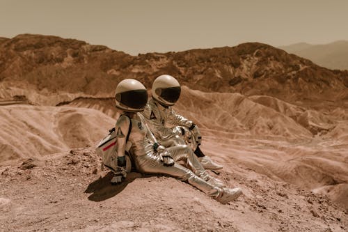 Astronauts Sitting on the Sand