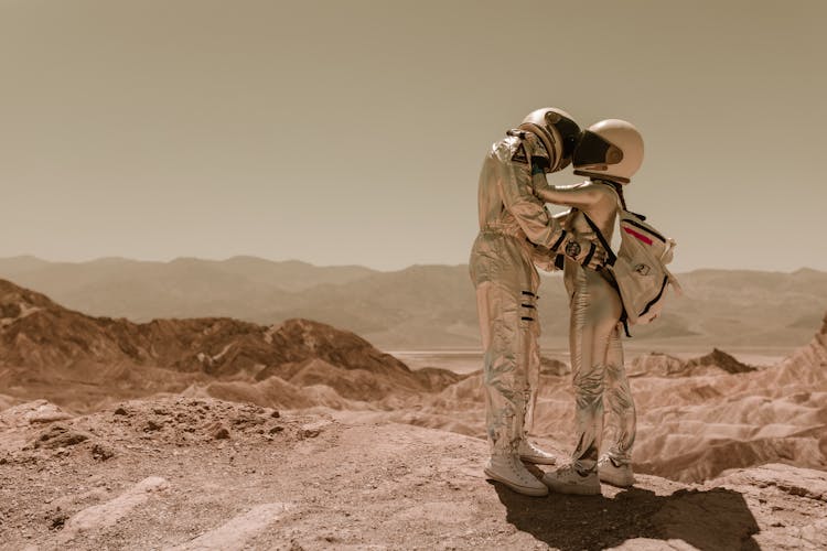 Astronauts Kissing While Wearing Space Helmets